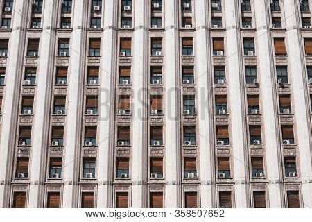 The Exterior Of An Old Soviet Era Style Building With Window Air Conditioning Machines.