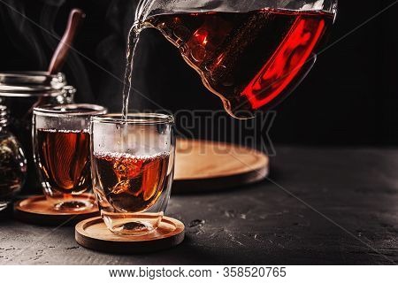 Process Brewing Tea, Tea Ceremony, Cup Of Freshly Brewed Black Tea, Dark Moody.hot Water Is Poured F