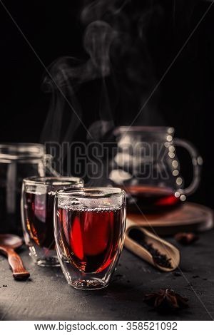 Cup Of Freshly Brewed Black Tea, Dark Moody, Tea Ceremony. Hot Water Is Poured From The Kettle Into 