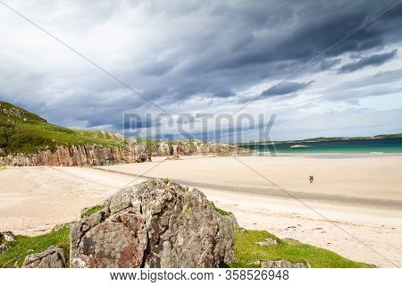 Beautiful View After A Storm Of Ceannabeine Beach With A Couple Walking Together In The Distance In 