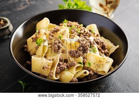 Pasta Calamarata With Minced Meat In Black Bowl. Italian Cuisine.