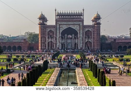Agra, India - March 5 2018: Tourists Sighteseeing, Exploring And Admiring Famous The Taj Mahal From 
