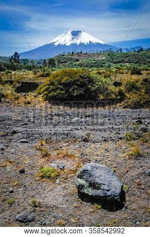 View Of The Cotopaxi Volcano On A Sunny Morning, With Volcanic Rocks In The Foreground. Cotopaxi Nat