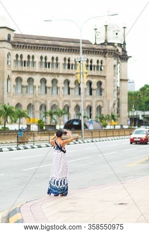The Kuala Lumpur Railway Station. Malayan Railways Hub. Young Woman Tourist Walk Around Building. Ku