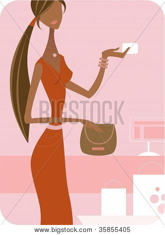 在用信用卡购买的橘红色衣服的女人