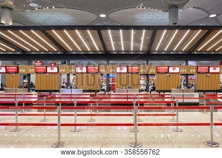 Istanbul, Turkey - October 8, 2019: Empty check-in area with red plastic tapes of Turkish Airlines in new main Istanbul International Airport.