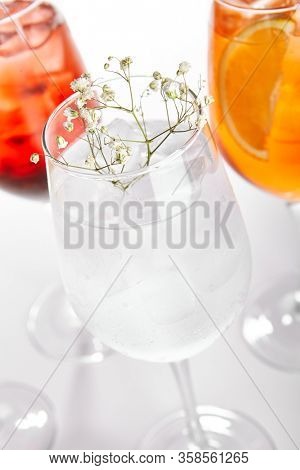 Spritz fruit cocktails. Alcohol soft drinks in glasses side view. Refreshment beverage with coconut, berry, orange in drinkware. Exotic summer beach cocktail portions with crushed ice in glassware