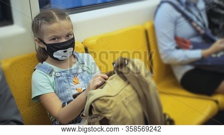 Little Girl Travel Caucasian Ride At Overground Train Airtrain With Wearing Protective Medical Red M