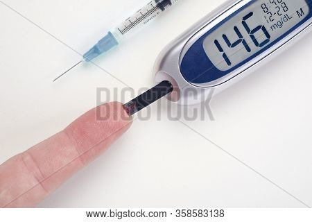 Diabetes, Glucometer With Finger Glucose Measurement With Blood Drop