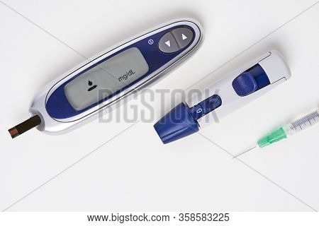 Diabetes, Glucometer With Glucose Measurement On Screen And Blood On Test Strip