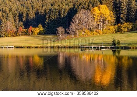 autumn pond under the mountains, Murau district,
Styria, Austria