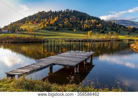 autumn pond under the mountains, Murau district,
Styria, Austria