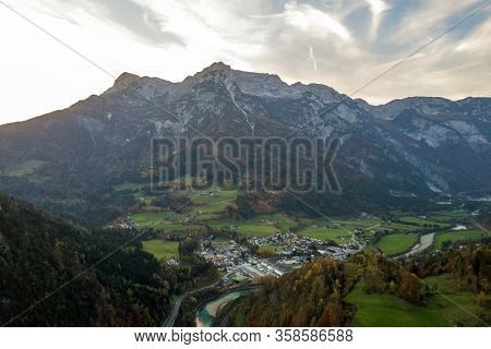 Aerial View Of Green Meadows With Villages And Forest In Austrian Alps Mountains.