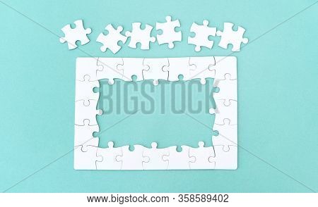 Top view of jigsaw puzzle with pieces for lettering