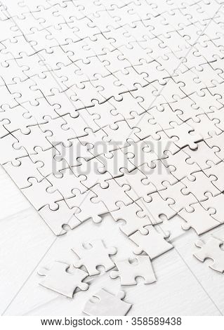 Little white pieces completing big blank puzzle
