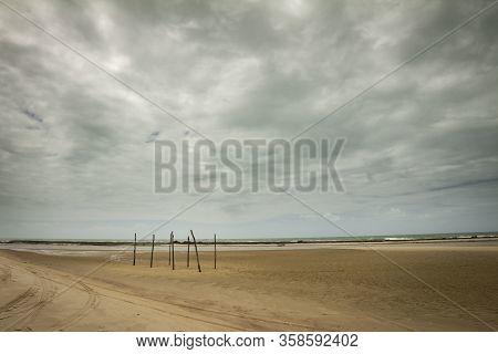 Deserted Beach In The North Of Brazil. Wooden Posts To Hang Hammocks On The Now Deserted Beaches. St