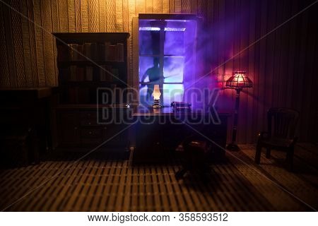 A Realistic Dollhouse Living Room With Furniture And Window At Night. Artwork Table Decoration With