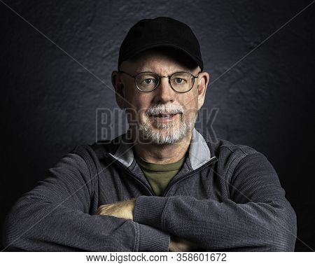Artistic Studio Portrait Headshop Of A Cheeerful Senior In Black And White.