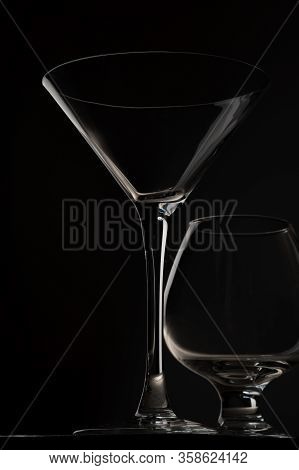 Close-up Two Empty Glasses For Whiskey And Alcoholic Cocktails Stand On A Black Background In The St