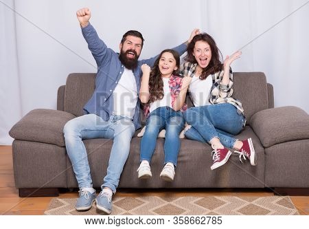 Together We Make Family. Happy Family At Home. Little Child And Parents Celebrate Victory. Protect Y