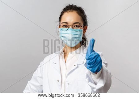 Doctors, Infectionist, Research And Covid19 Concept. Confident Young Happy Asian Female Doctor Show 