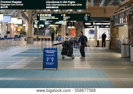 Richmond, Bc, Canada - Mar 29, 2020: Traveller In The International Departures Section Of Yvr Which 