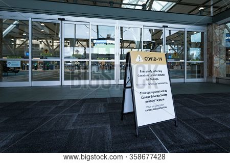 Richmond, Bc, Canada - Mar 29, 2020: A Public Health Notice Sign At Yvr Advising Returning Traveller