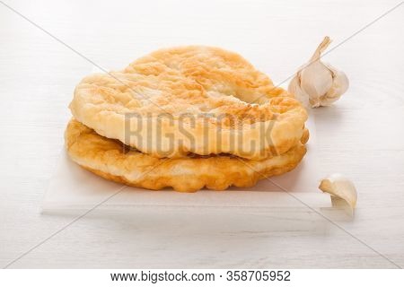 Traditional Hungarian Food Specialty Langos With Garlic On White.