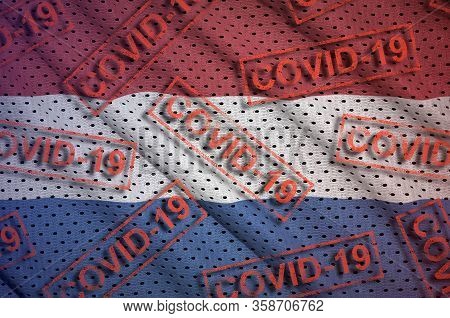 Netherlands Flag And Many Red Covid-19 Stamps. Coronavirus Or 2019-ncov Virus Concept