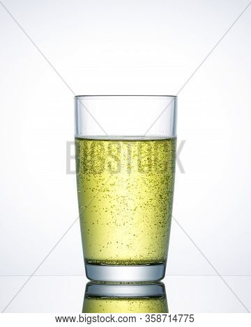 Glass Of Sparkling Water Yellow With Air Bubbles