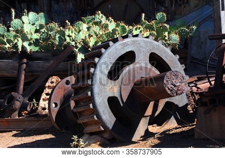Mining Equipment Remnants From The Turquoise Mining Industry Lays Besides A Wooden Wagon Filled With