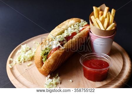 Hot Dogs With French Fries And Ketchup On Wooden Plate.