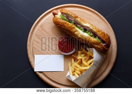 Hot Dogs With French Fries And Ketchup On Wooden Plate.