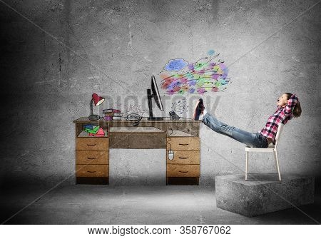 Young Happy Woman Relaxing In Room. Creative Freelance Designer Sitting On Chair And Putting Feets O