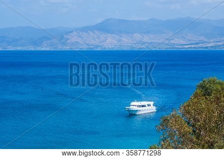 Summer Seascape On Cypus. View To The Bay With Green Grove In Front And Blue Clouded Sky. View From 