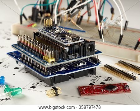Arduino And Programmers With Peripherals And Expansion Boards Lie On A Gray Background. Do It Yourse
