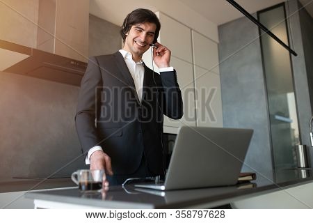 Businessman Works From Remote At House With A Laptop Due To Coronavirus Quarantine.