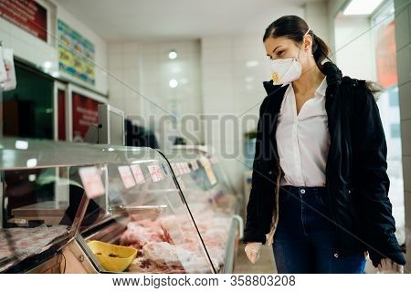 Woman With Protective Mask Shopping For Supplies.budget Shopping.buying Fresh Meat At A Butchery.bee