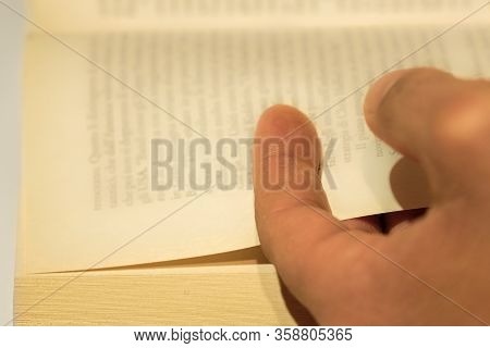 Rome, Italy - March 29 2020: Soft Focused Human Hand Closeup While Reading An Hold Vintage Book, Kno