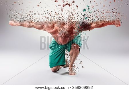 Sexy Muscular Bodybuider Kneeling  And Posing On The Gray Background. Breakdown Effect