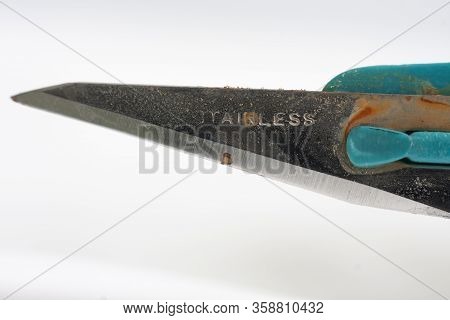 Close Up Of Rusty Medical Scalpel On White Background.