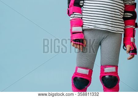 Close Up Image Of A Little Girl In Pink Protective Gear For Skating Over Blue