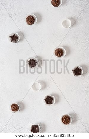 Homemade Dark And Milk Chocolate Pralines Candies On White Background. Top View, Flat Lay. Chocolati