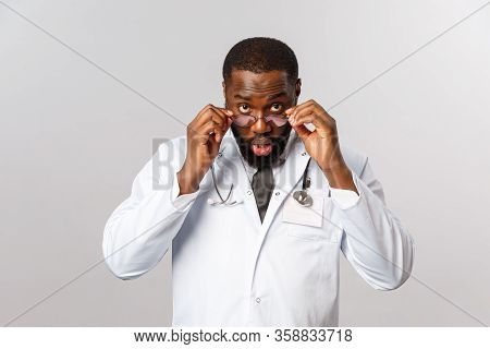 Healthcare, Medicine And Hospital Treatment Concept. Impressed And Surprised African-american Doctor