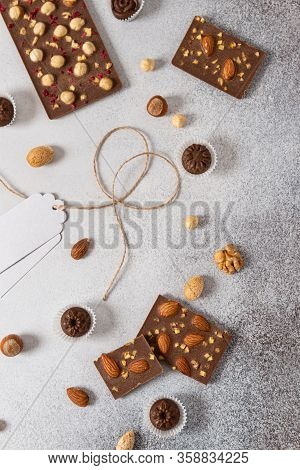 Milk Chocolate Bars And Candies With Nuts On Light Background. Homemade Organic Chocolate. Handmade 
