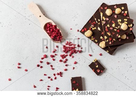 Handmade Dark Chocolate Bars With Nuts And Dried Fruits On White Background. Top View