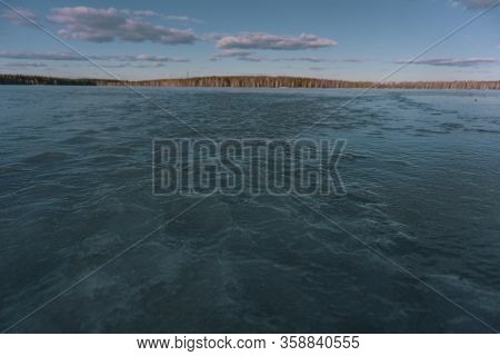 The Turquoise Sky And The Ice Of A Frozen Pond Lake
