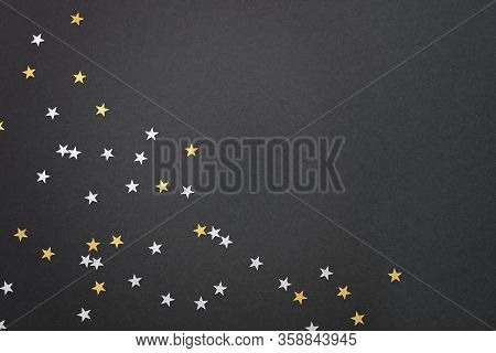 Festive Black Background With Silver And Gold Star Confetti, Empty Space