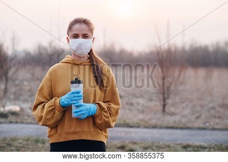 Covid-19 Pandemic Coronavirus Girl In Mask And Blue Gloves During Quarantine
