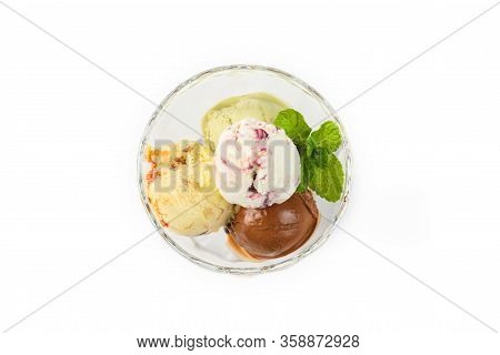 Colored Balls Of Ice Cream In A Glass Cremant On An Isolated Background.